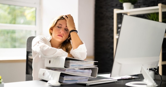 Stressed woman overwhelmed at work